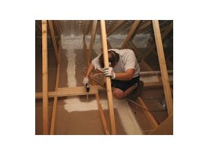 Worker air sealing an attic.