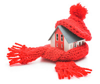 house wrapped in knitted scarf and hat