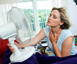 Women using a fan on a hot day.