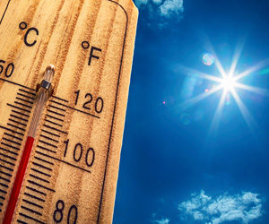Closeup of a thermometer on a hot day.