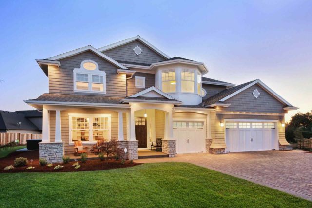 Exterior of a large new home in the evening.