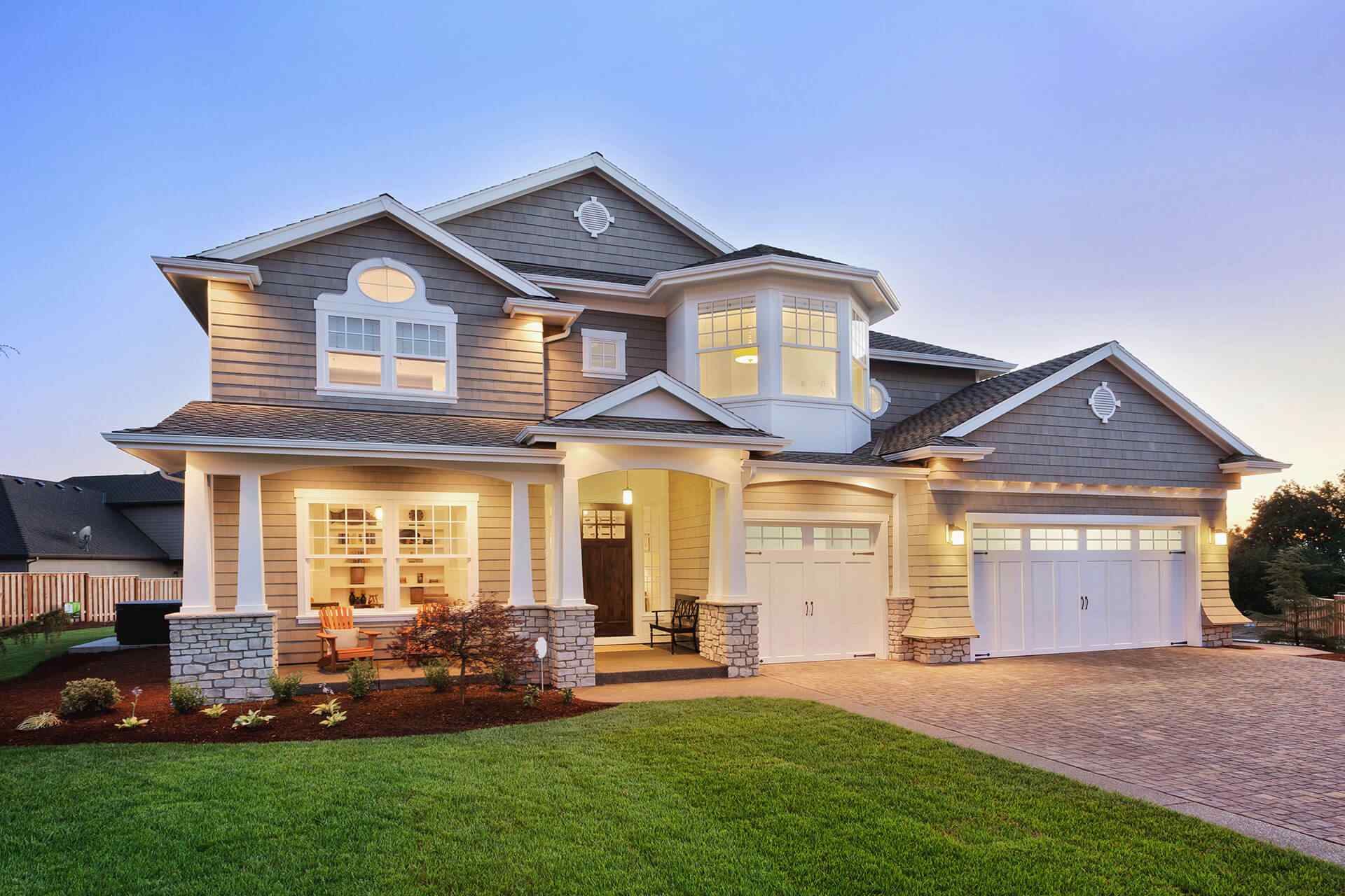 Exterior of a large new home in the evening.