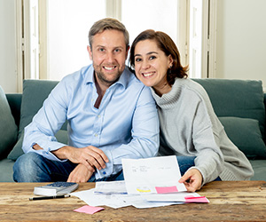 Smiling couple with documents on the table