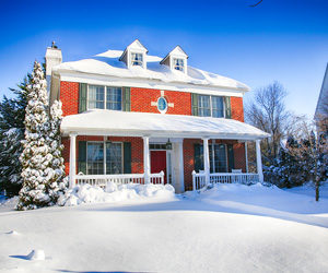 Exterior of a home and yard covered in snow.