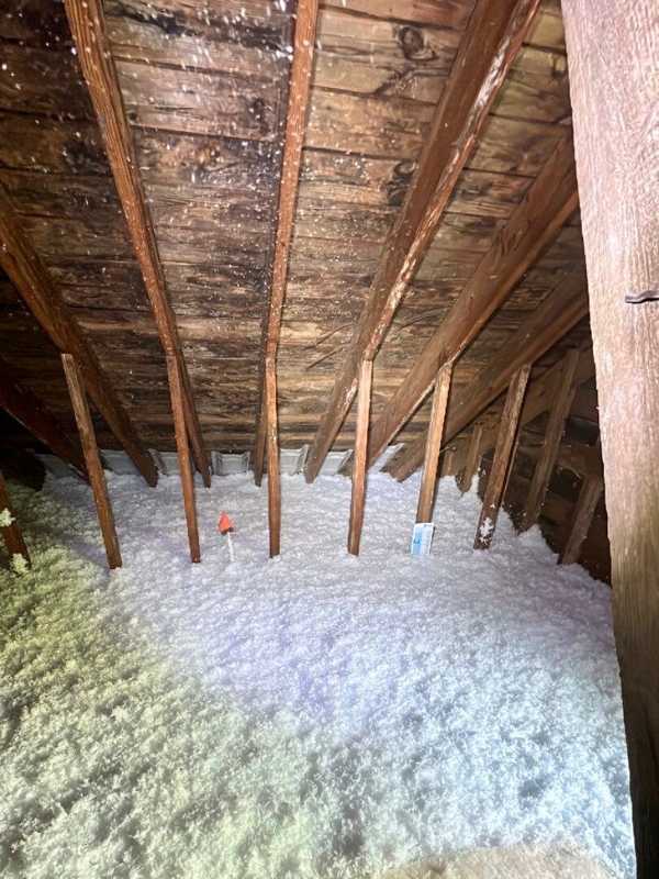 Loose fill, fiber glass insulation blown in attic