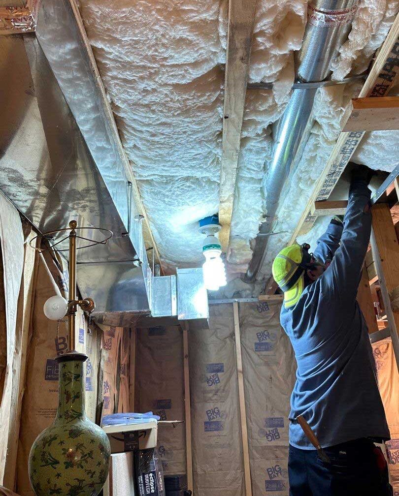 Batt insulation installation by DeVere Insulation Home Performance, highlighting a classic method for enhancing thermal resistance and comfort in residential areas.