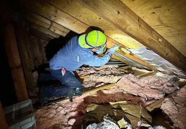 Insulation specialist insulating home's attic ventilation.