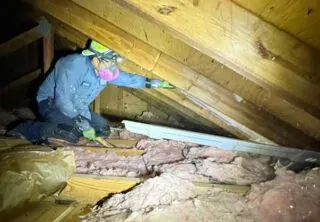 Insulation specialist insulating home's attic ventilation.