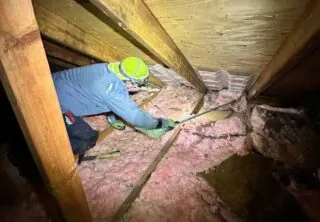 Insulation specialist insulating home's attic ventilation.