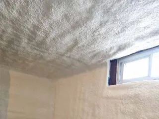 Closed-cell spray foam applied to both the rim-joist area and masonry wall.